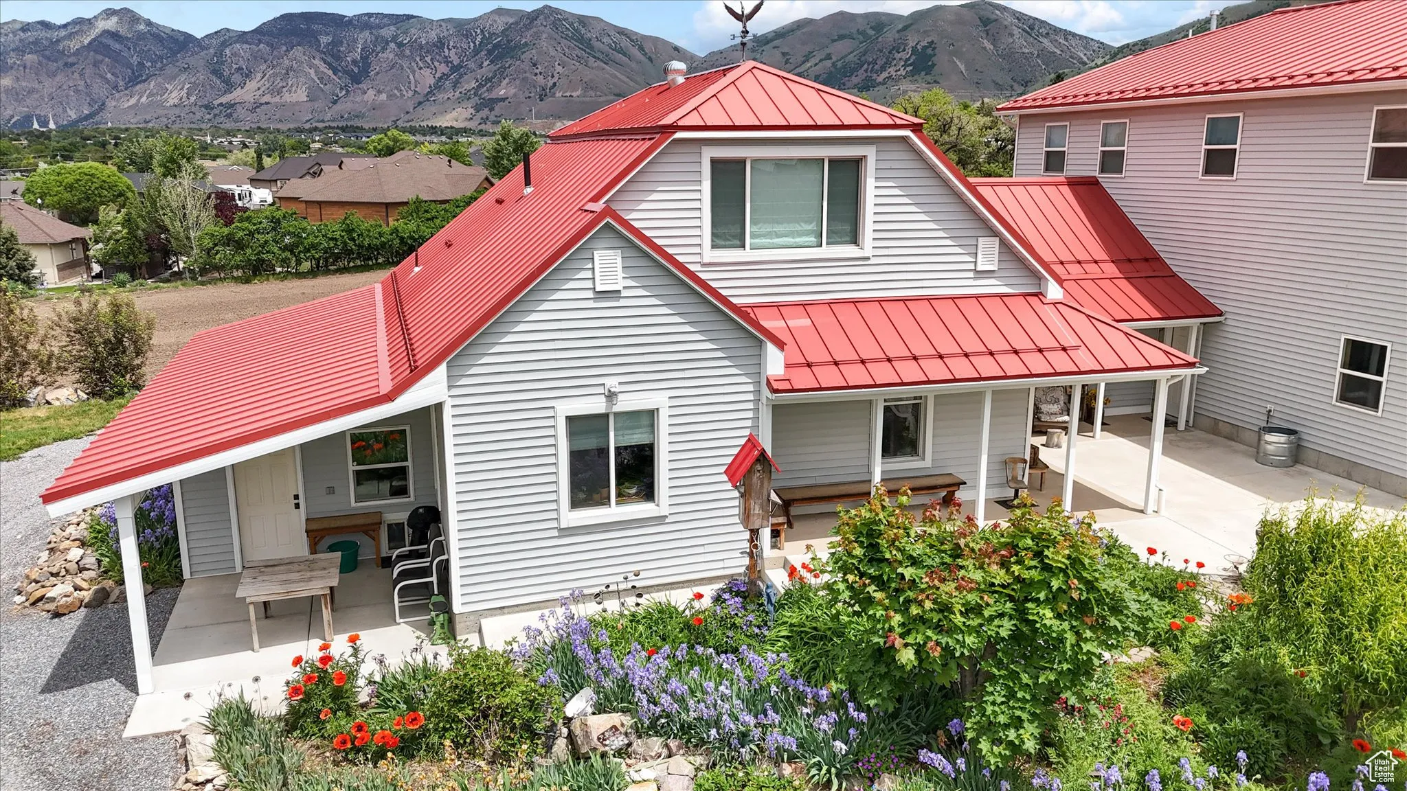 Back of property with a standing seam roof, a mountain view, and metal roof