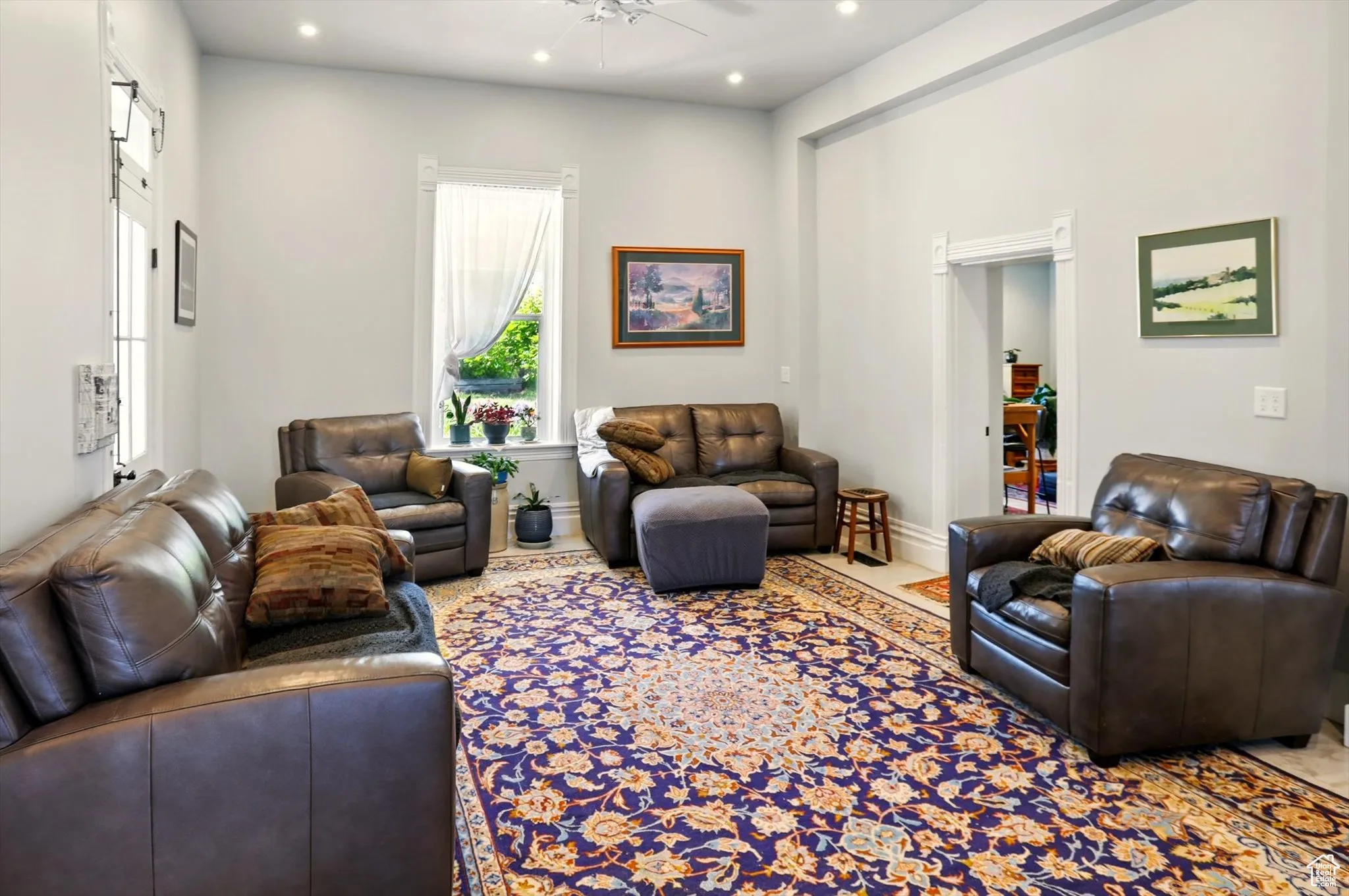 Living room with a ceiling fan and recessed lighting