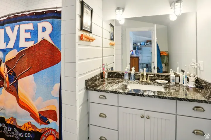 Full bath featuring vanity and a shower with shower curtain