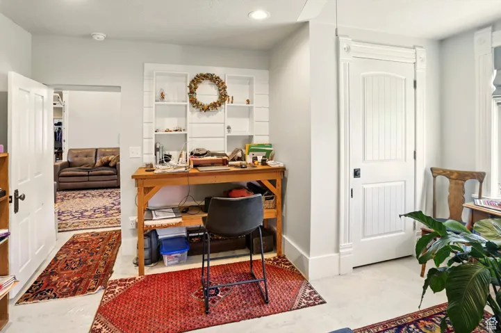 Office space with recessed lighting and baseboards
