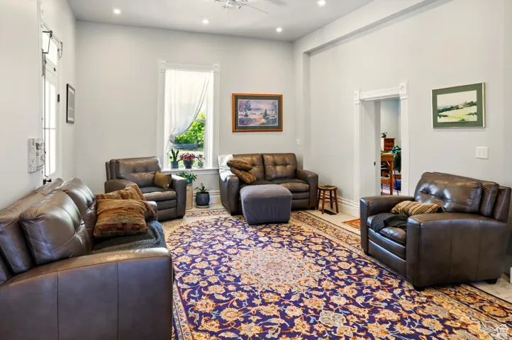 Living room with a ceiling fan and recessed lighting