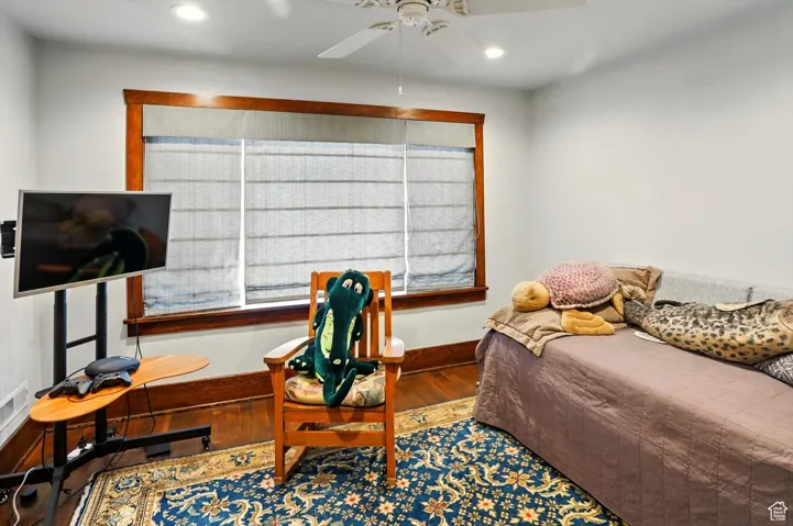Bedroom featuring wood finished floors, baseboards, recessed lighting, and a ceiling fan