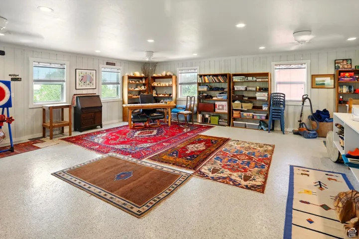 Office featuring recessed lighting, wood walls, and baseboards