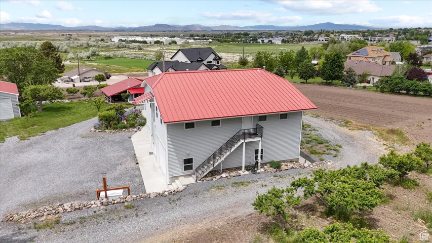 Aerial view of property and surrounding area with a mountain backdrop