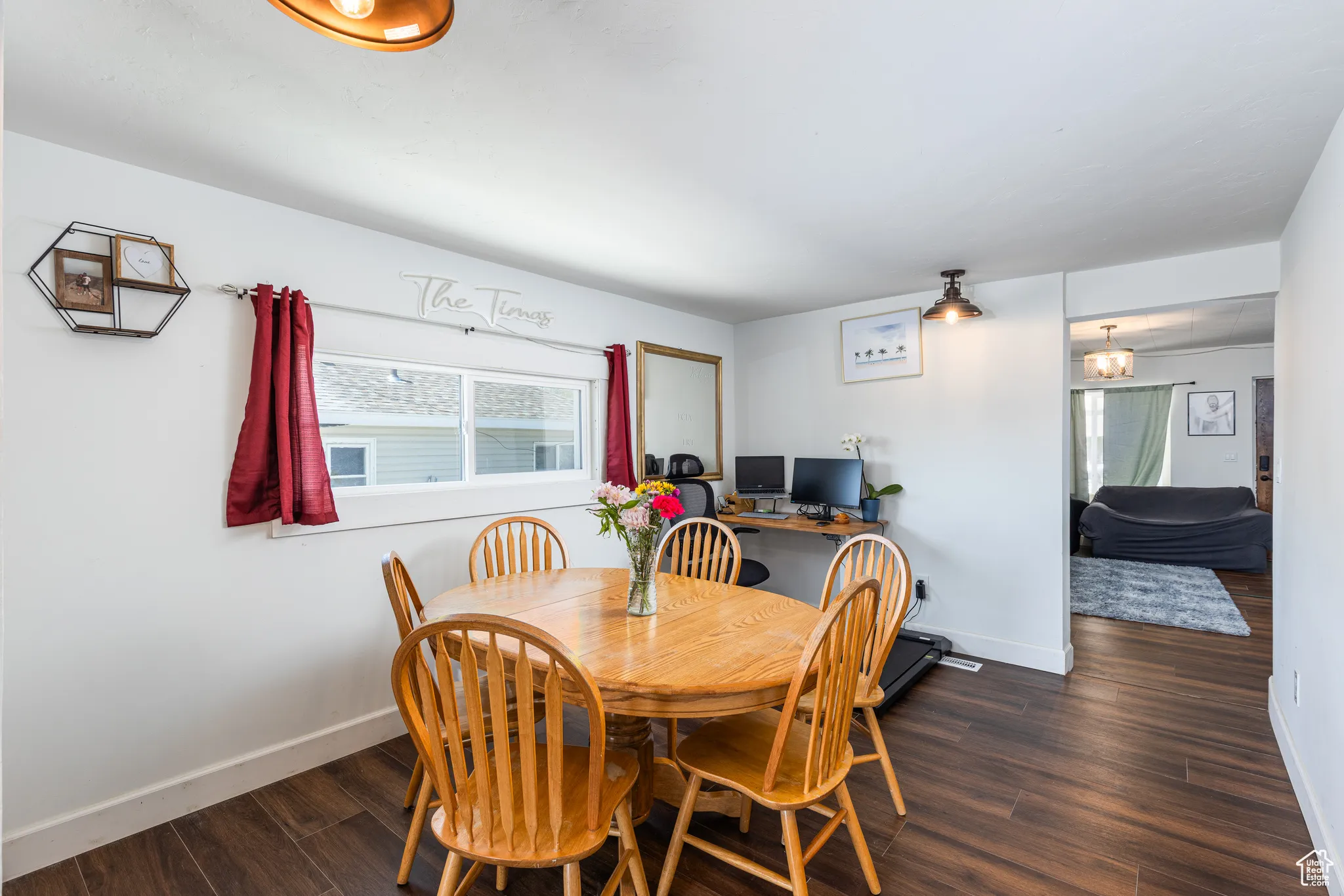 Dining room featuring wood finished floors and baseboards