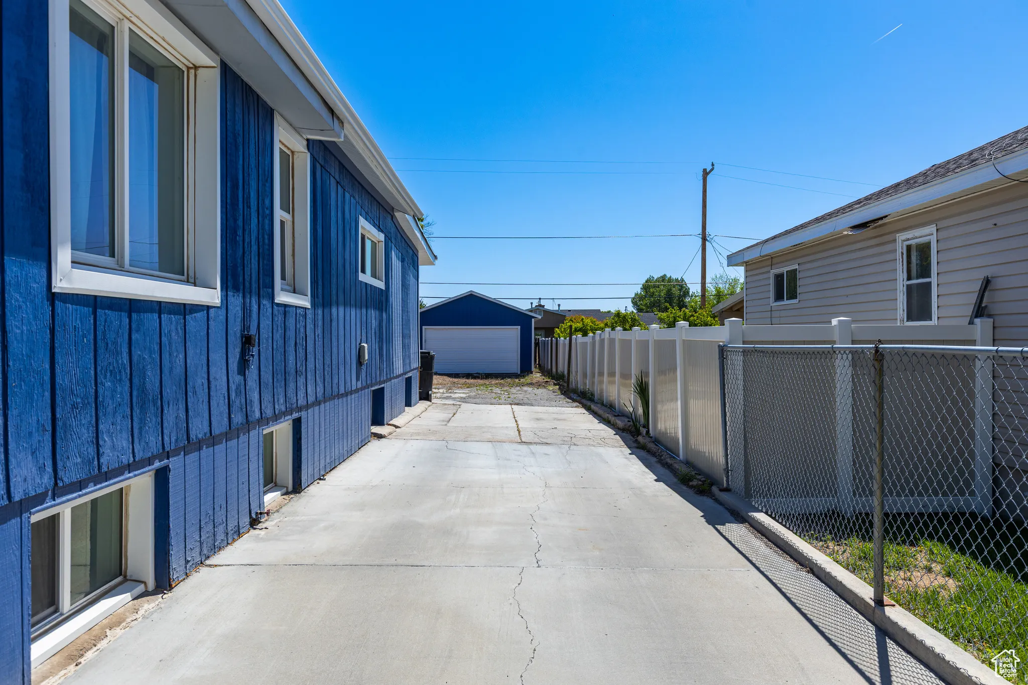 View of patio featuring concrete driveway and a detached garage