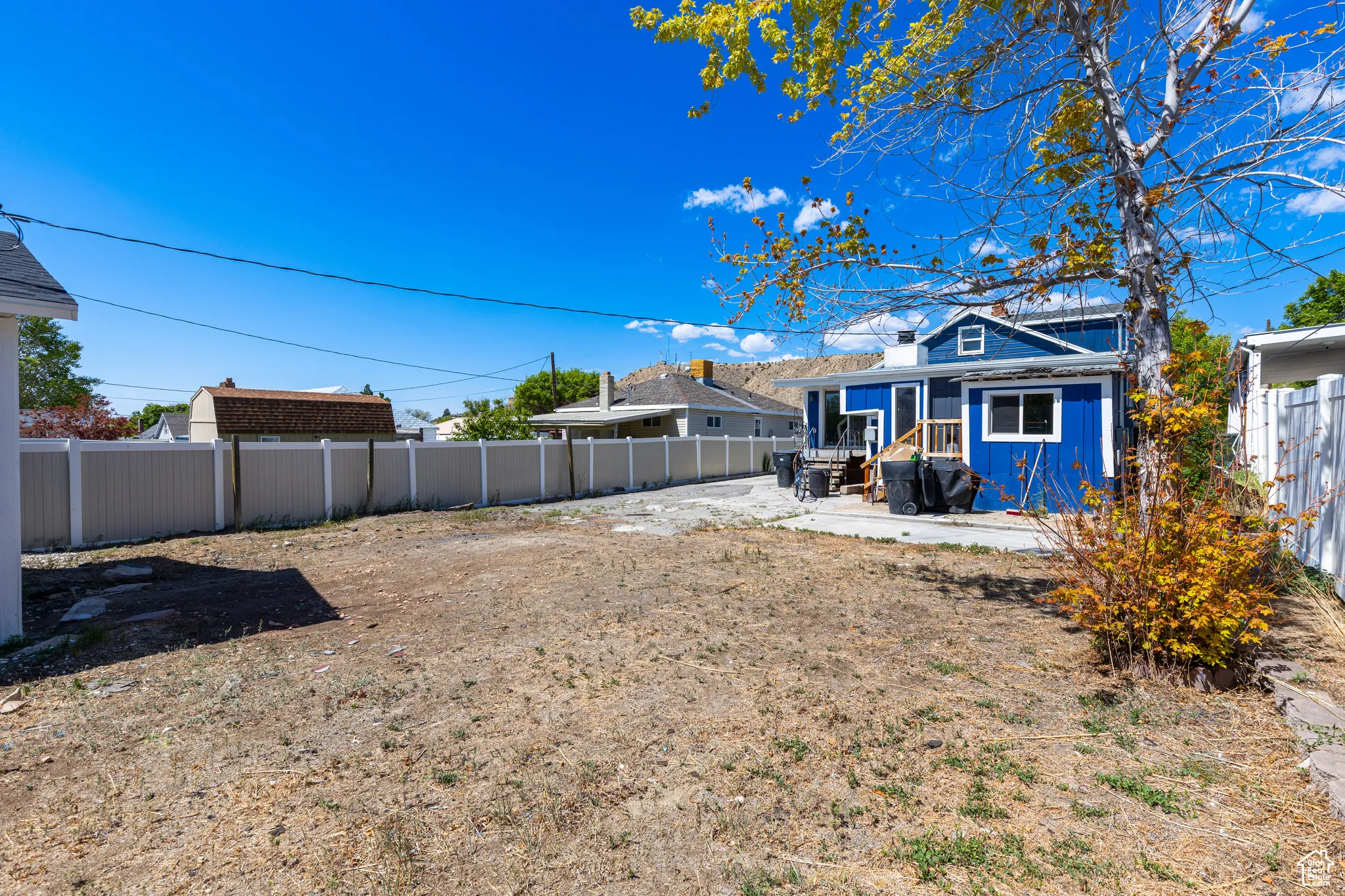 Fenced backyard with a patio