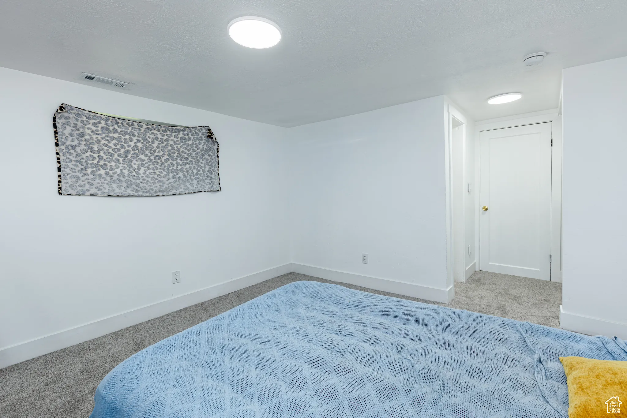 Carpeted bedroom with baseboards