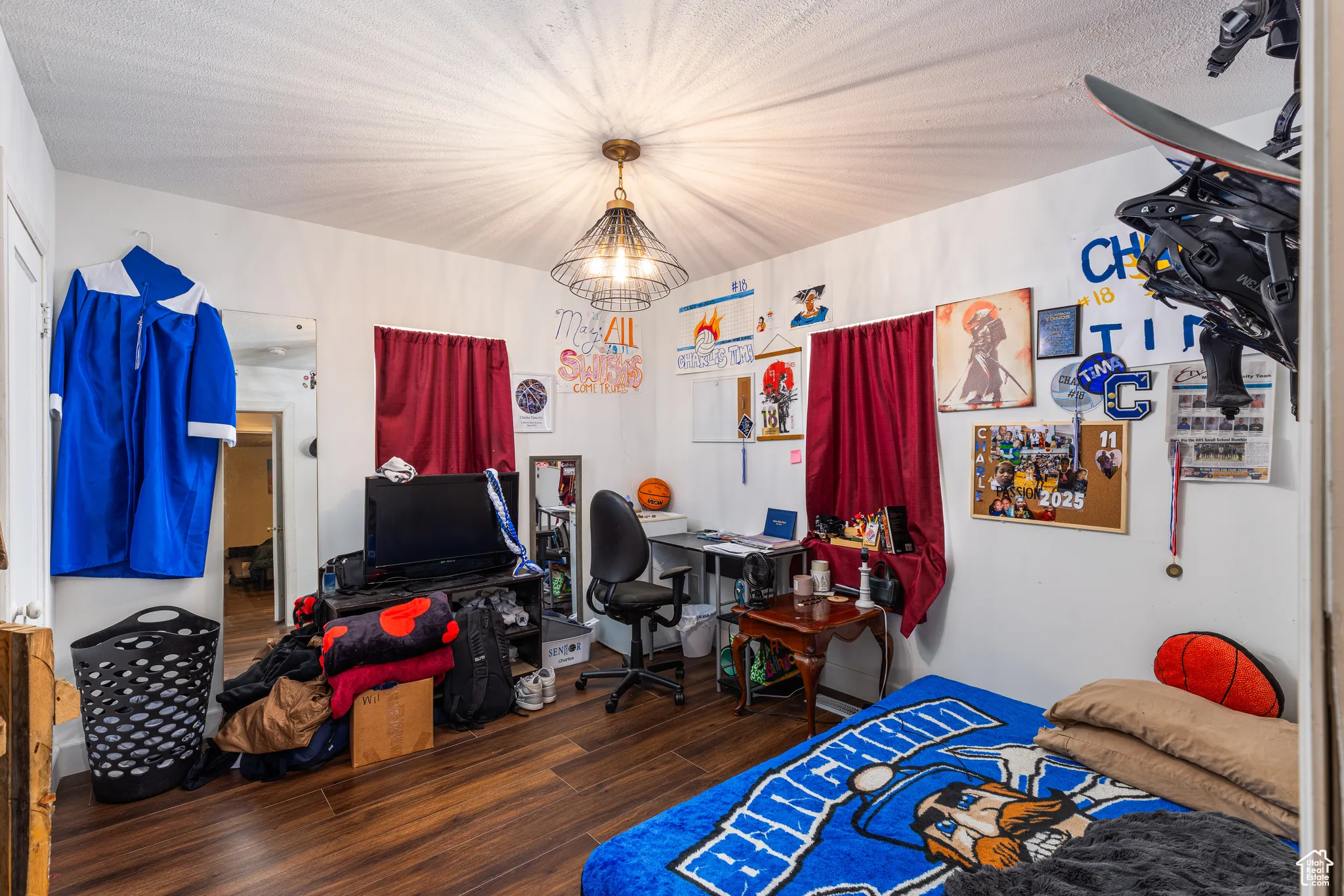Bedroom with wood finished floors and a chandelier