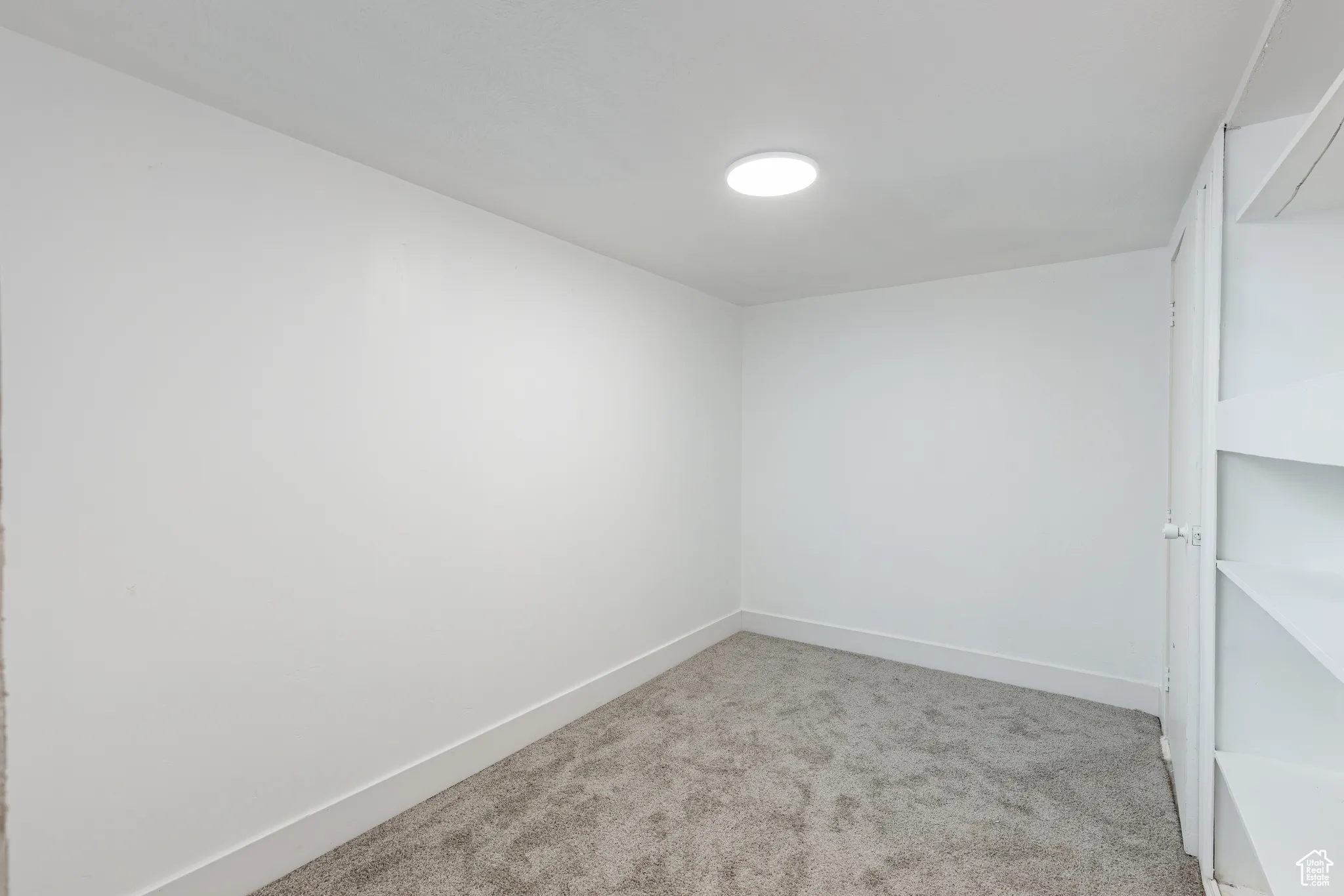 Carpeted spare room with baseboards