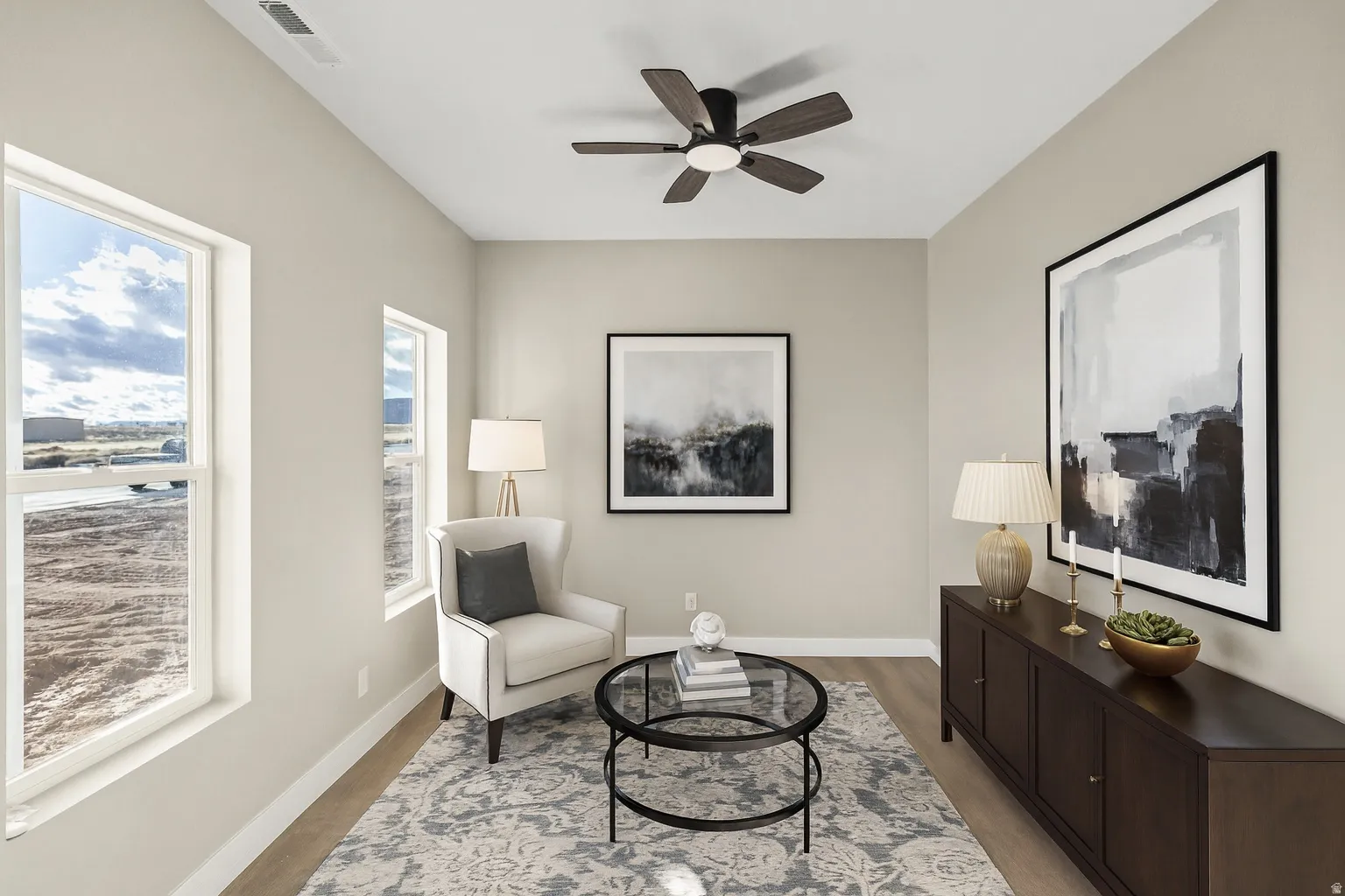 Living area with ceiling fan and light wood-style floors