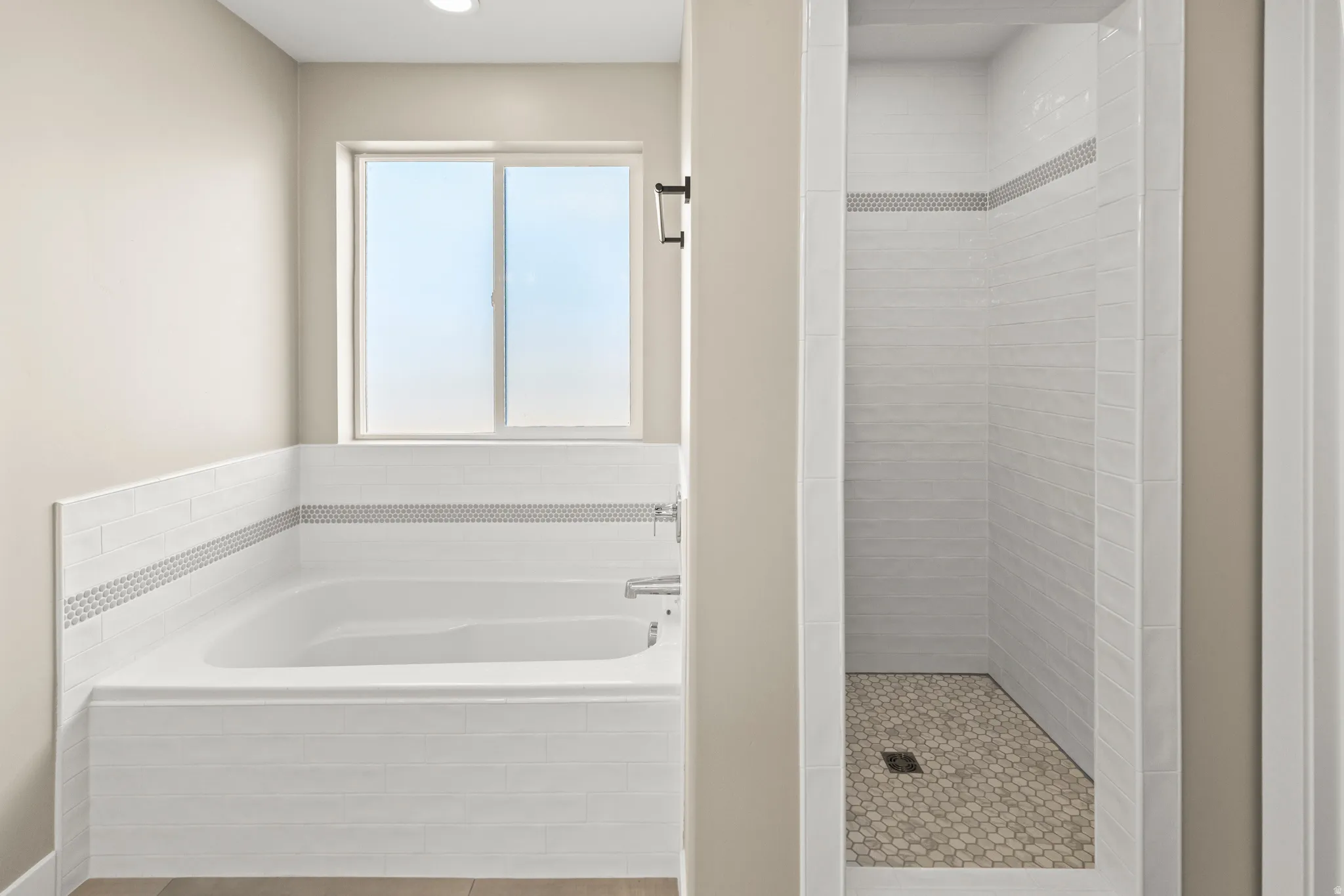 Full bath featuring a bath and a shower stall