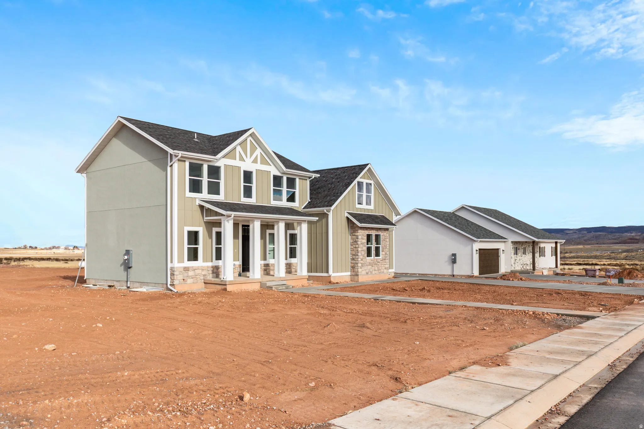 View of front of property with covered porch, a garage, and driveway