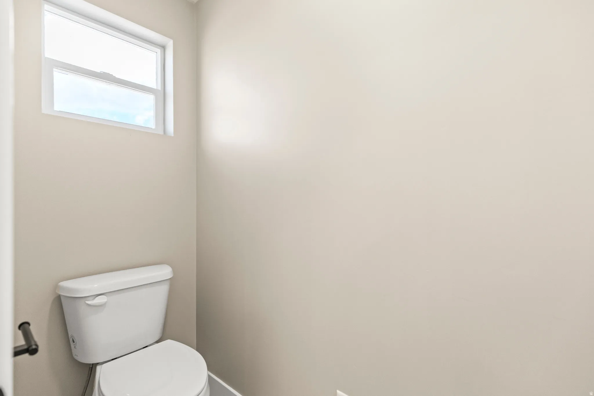 Bathroom featuring toilet and baseboards