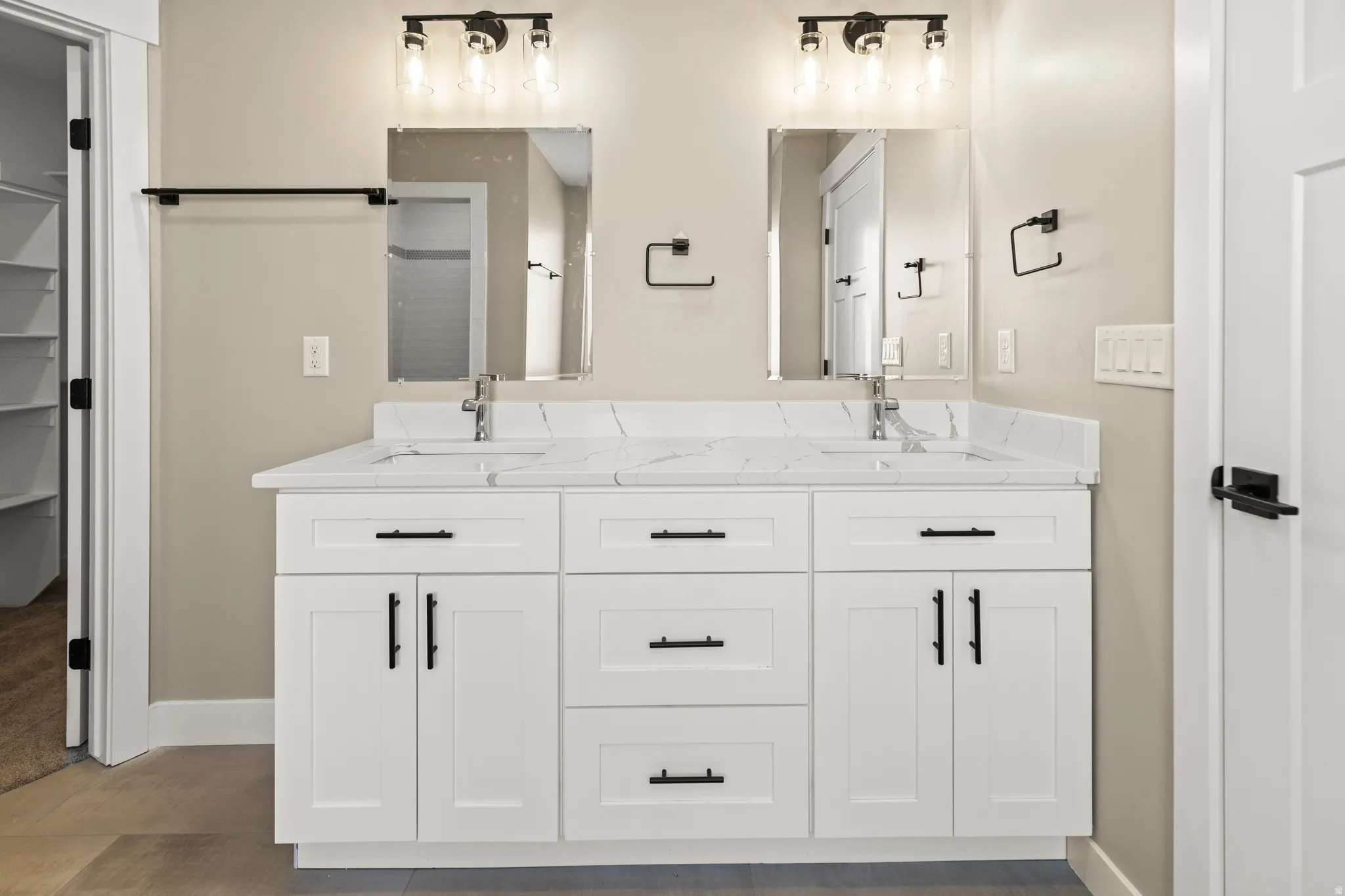 Bathroom with double vanity and a spacious closet