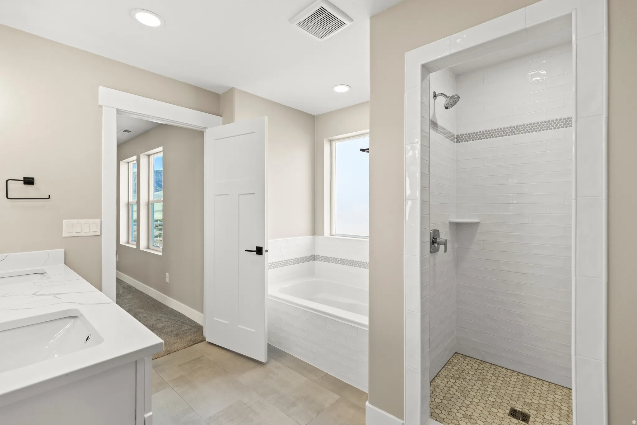 Full bath with a garden tub, a shower stall, double vanity, and recessed lighting