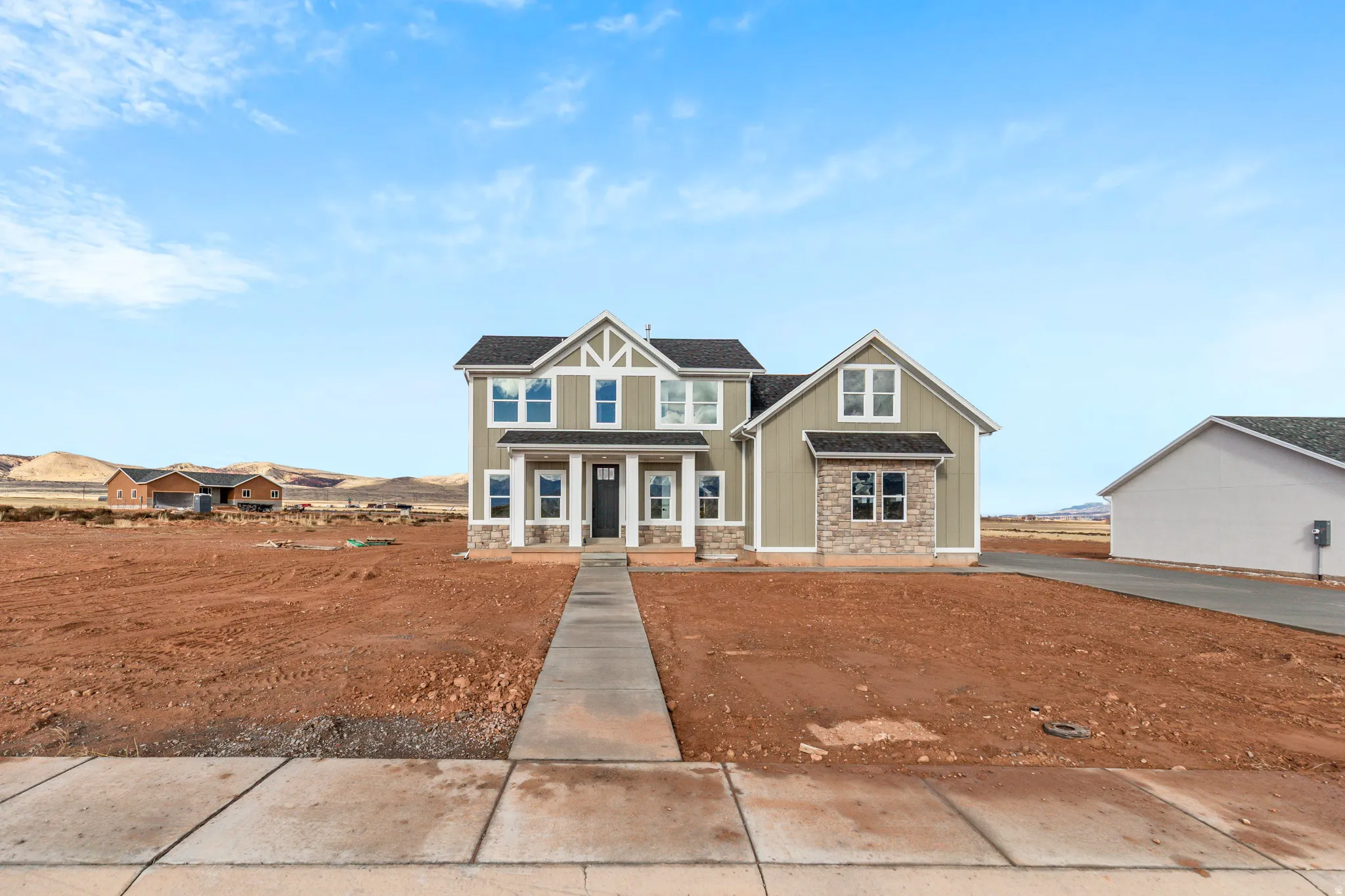 Craftsman house featuring board and batten siding, stone siding, and a porch