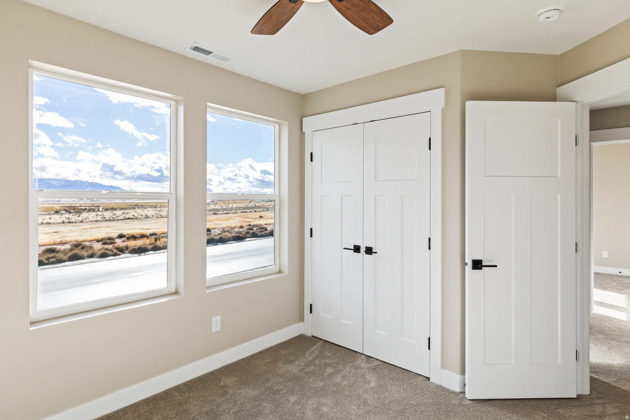 Unfurnished bedroom featuring carpet, a closet, and ceiling fan