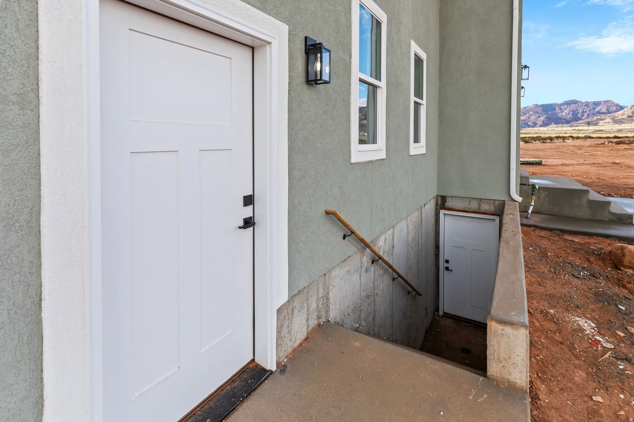 Entrance to property featuring stucco siding