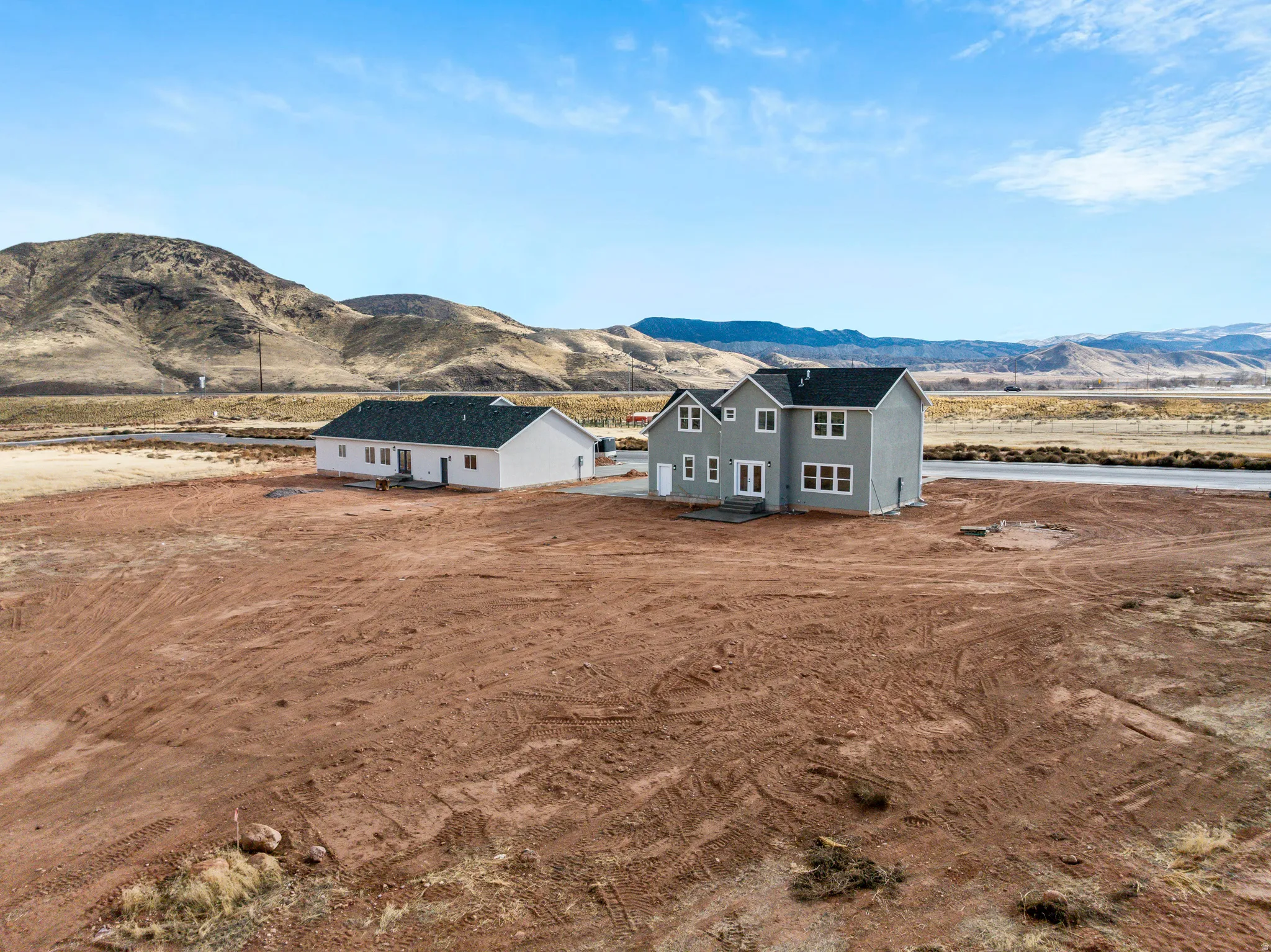 Aerial view of property and surrounding area with a mountainous background