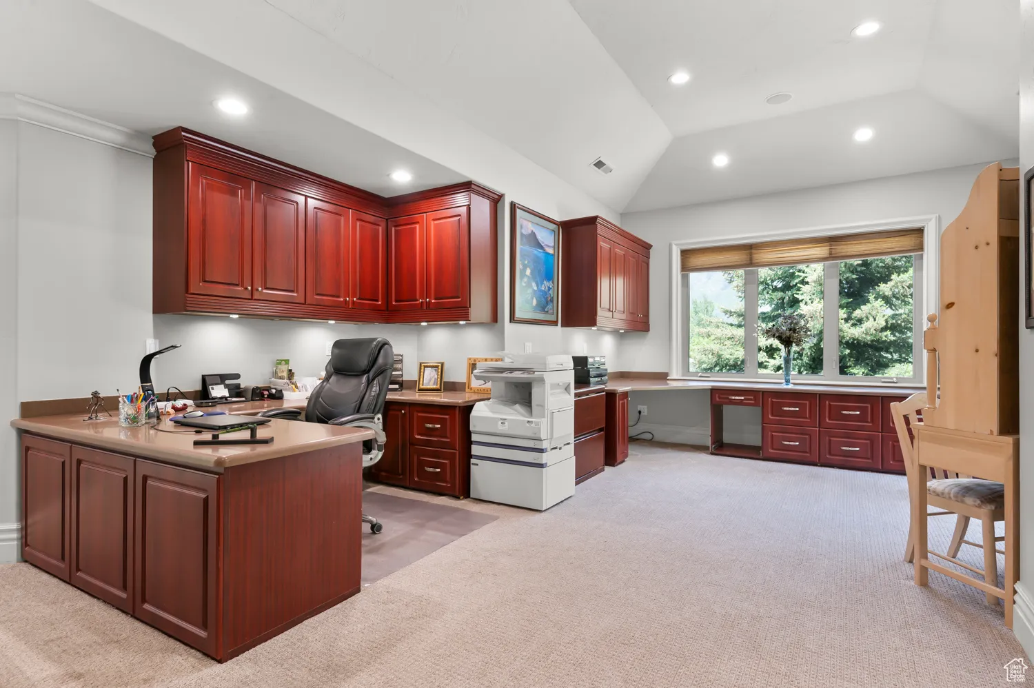 Office area featuring light carpet, built in desk, recessed lighting, and lofted ceiling