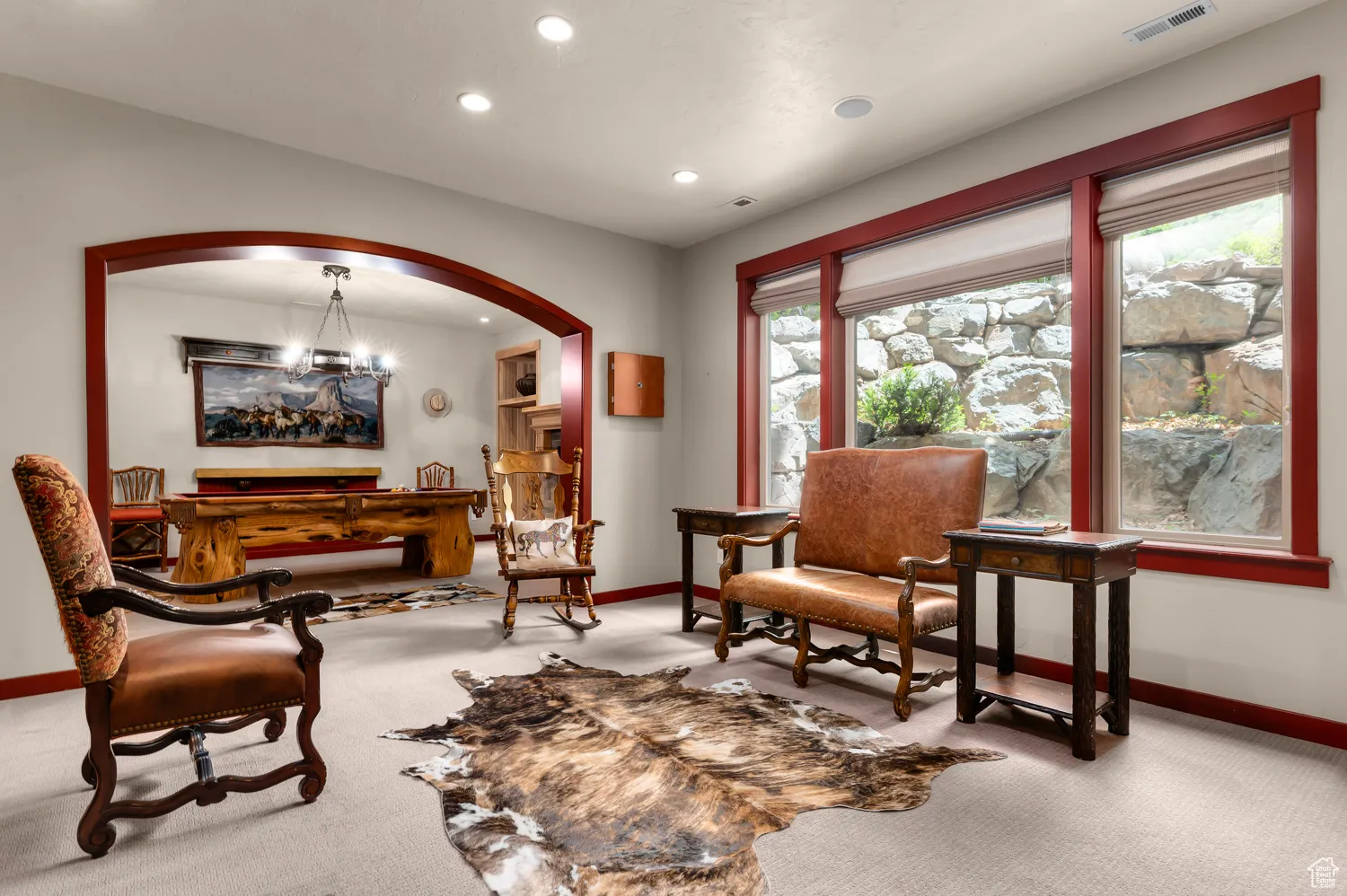 Sitting room with baseboards, carpet floors, recessed lighting, and arched walkways