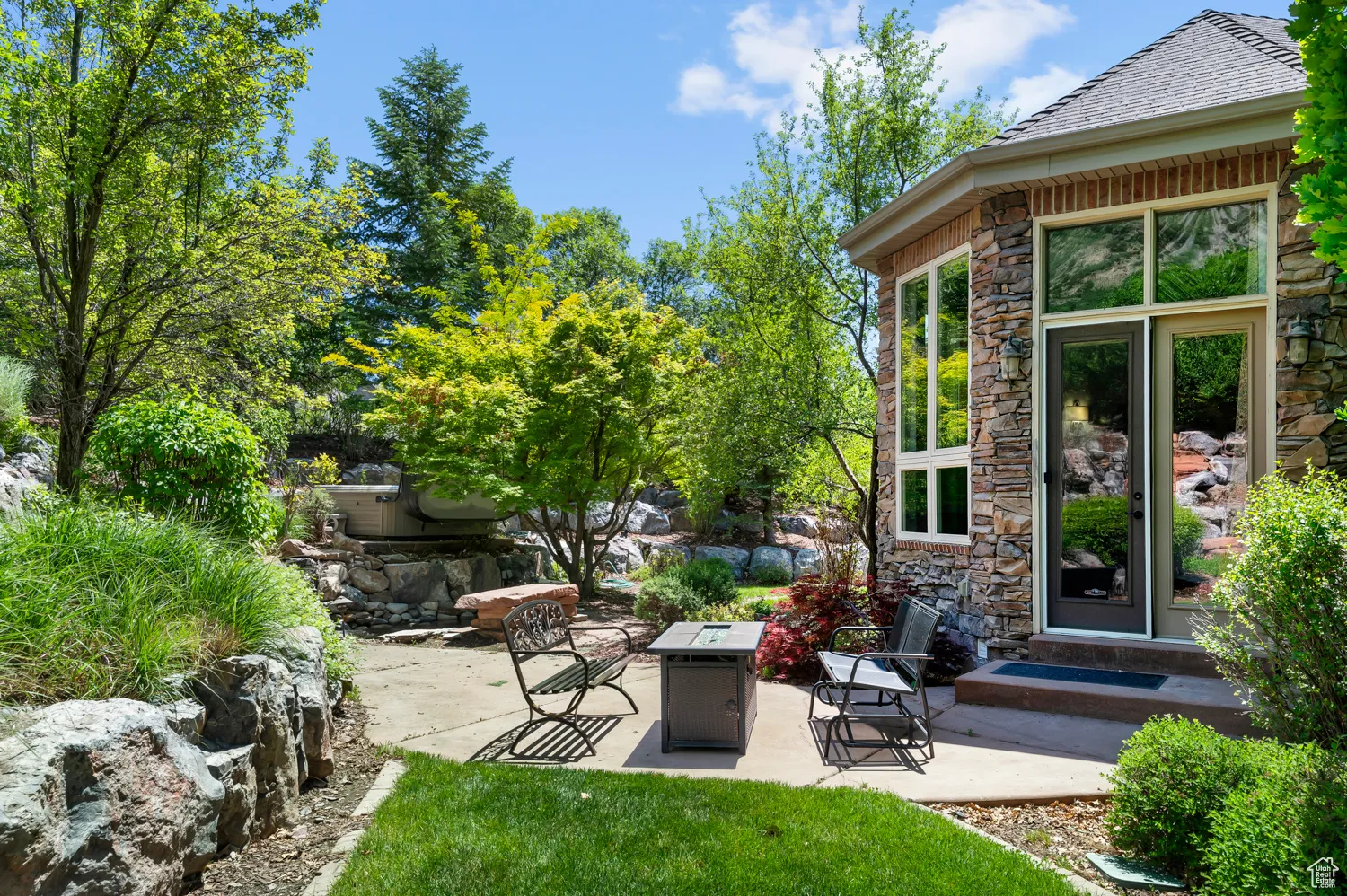 View of patio with an outdoor fire pit