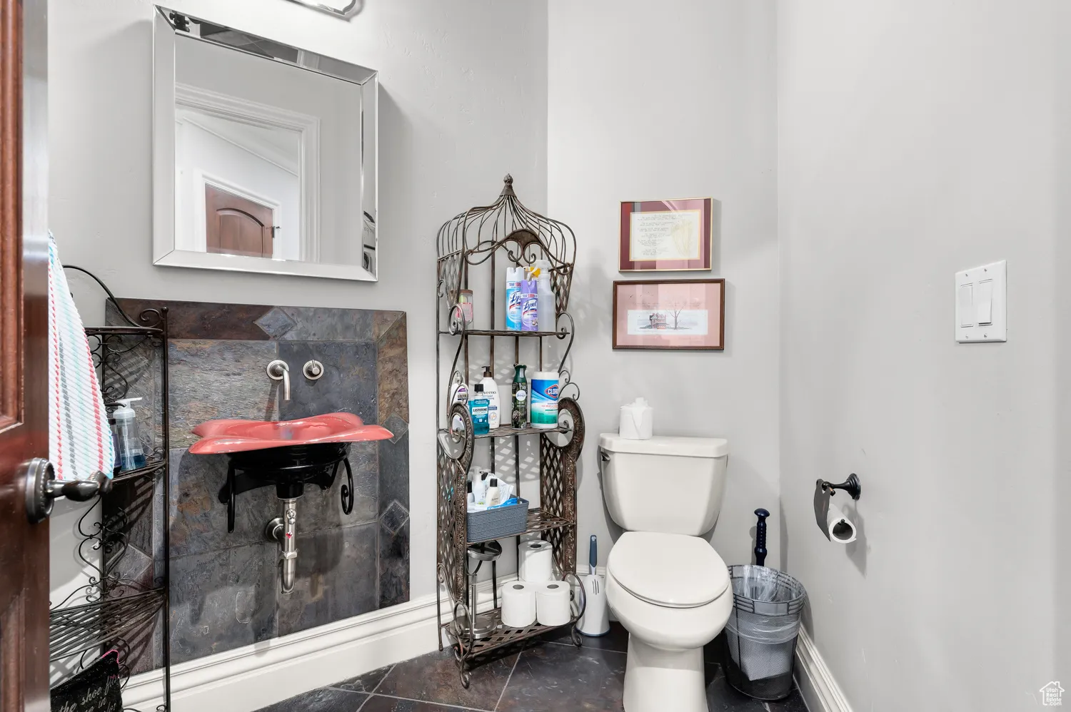 Bathroom with baseboards, toilet, and tile patterned floors