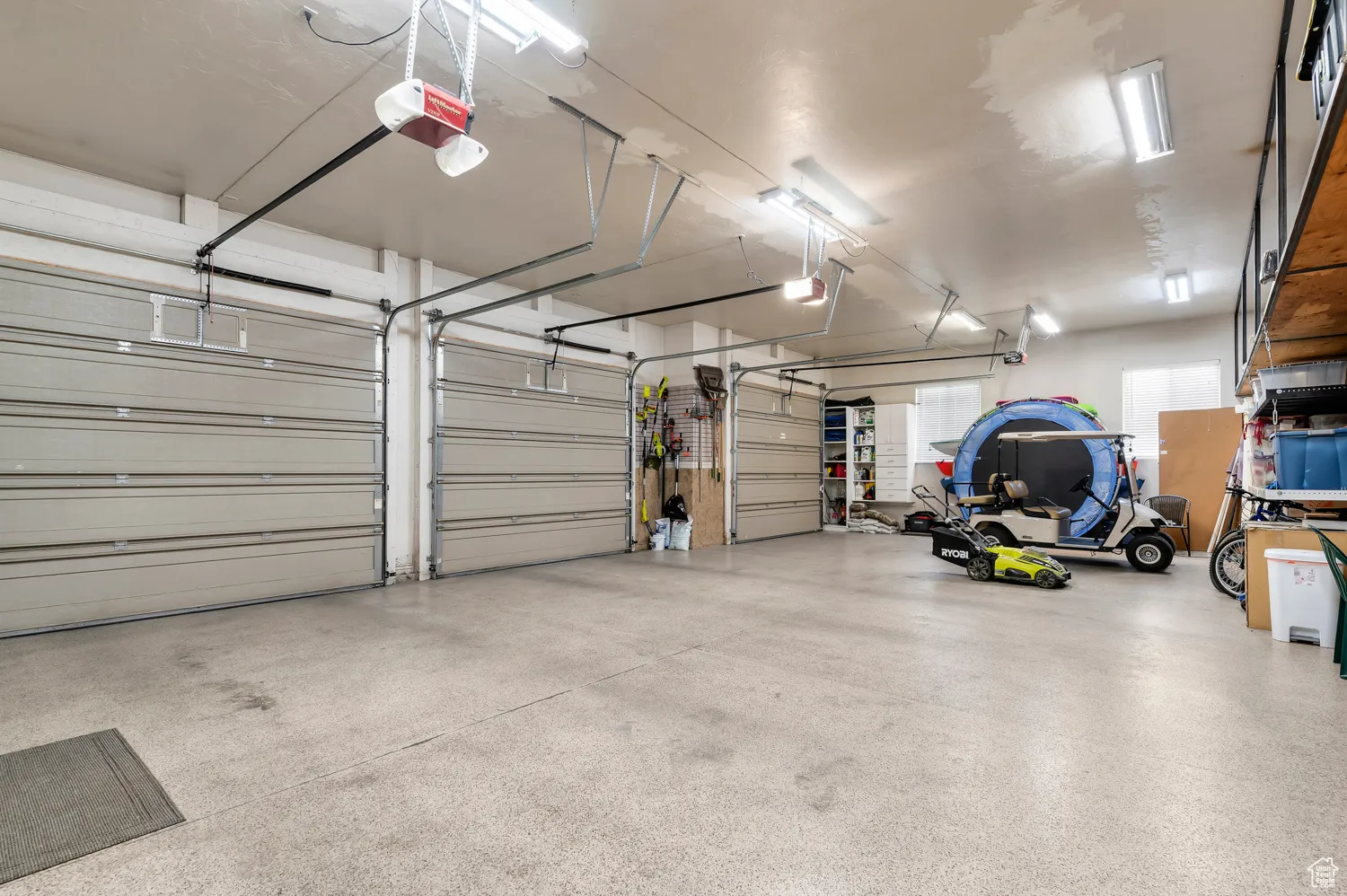 Garage featuring a garage door opener