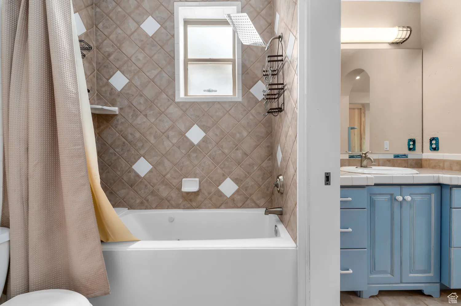Full bathroom featuring shower / tub combo, vanity, and toilet