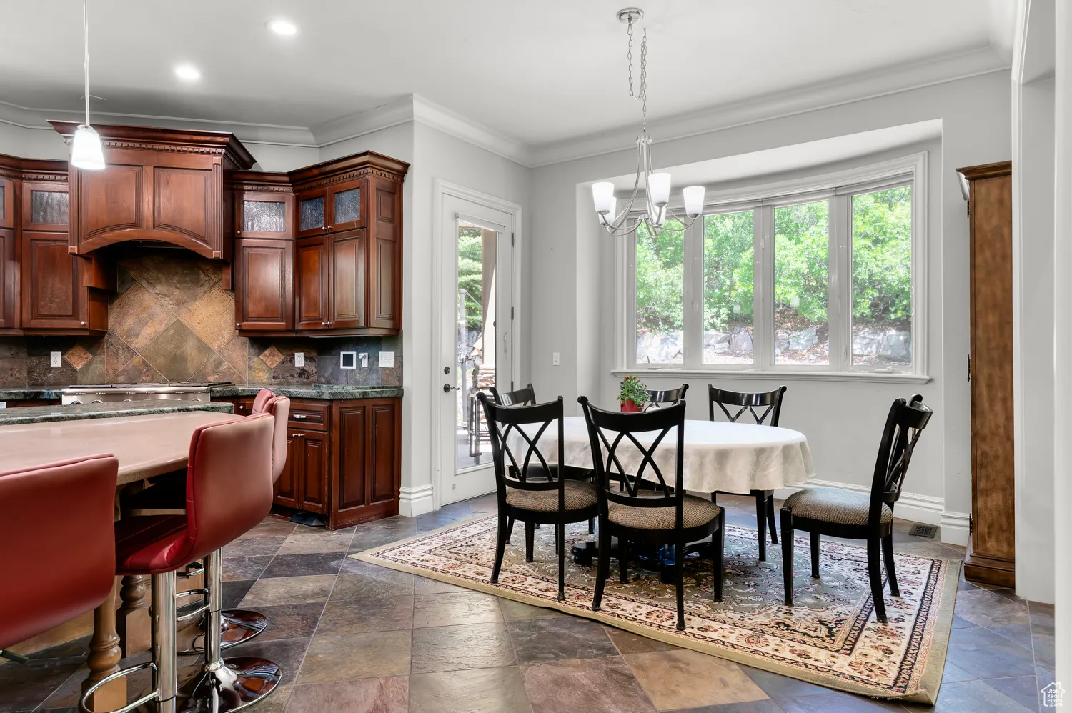 Dining room featuring plenty of natural light, a chandelier, crown molding, baseboards, and recessed lighting