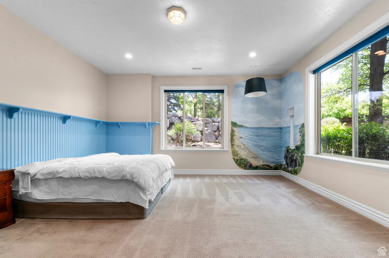 Carpeted bedroom with multiple windows, recessed lighting, and baseboards