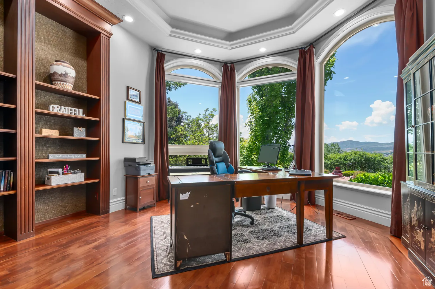 Office area featuring plenty of natural light, hardwood / wood-style floors, a raised ceiling, recessed lighting, and ornamental molding