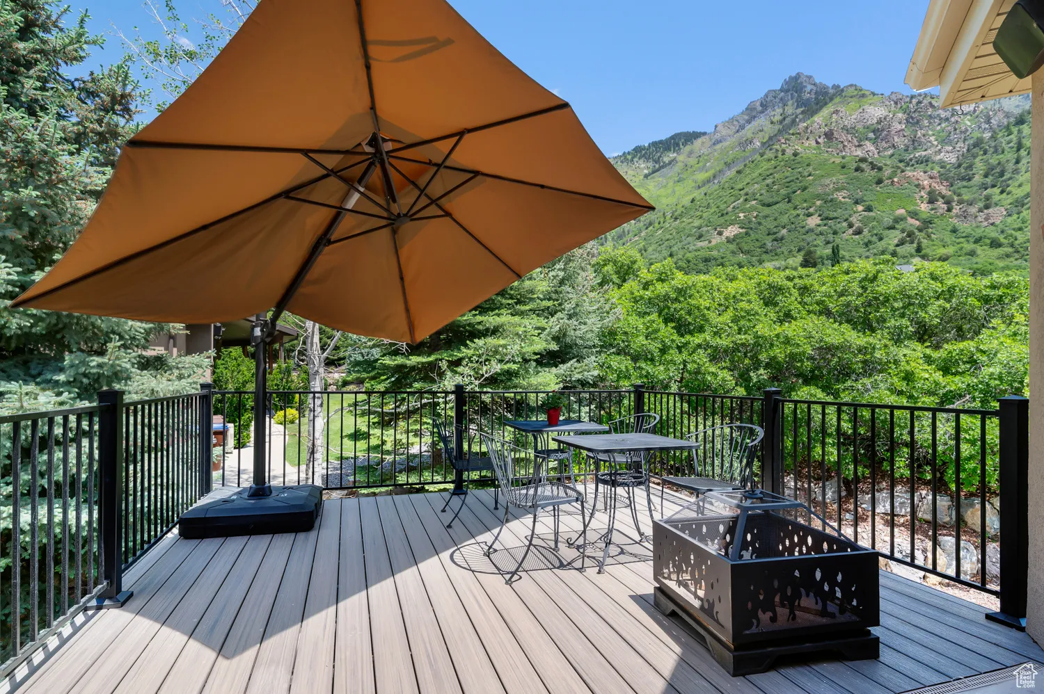 Wooden deck with a mountain view and outdoor dining space