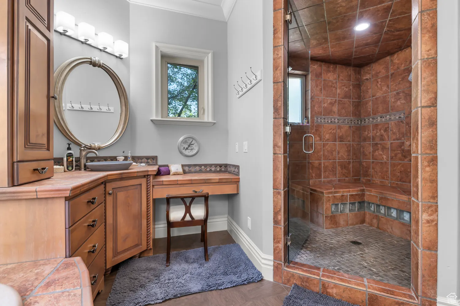 Bathroom with a shower stall, vanity, recessed lighting, and baseboards