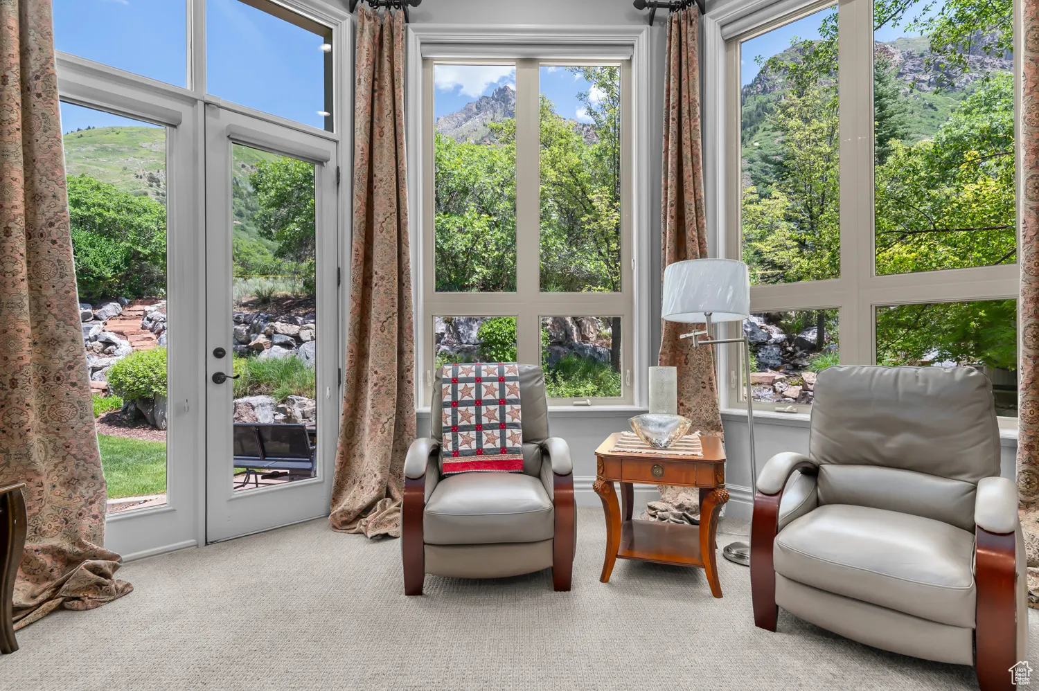 Sunroom / solarium with french doors, a mountain view, and carpet