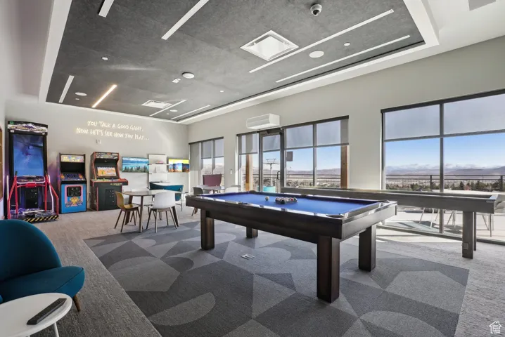 Recreation room featuring carpet flooring, plenty of natural light, and billiards table