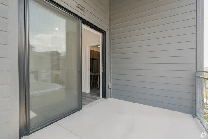 View of patio with a balcony