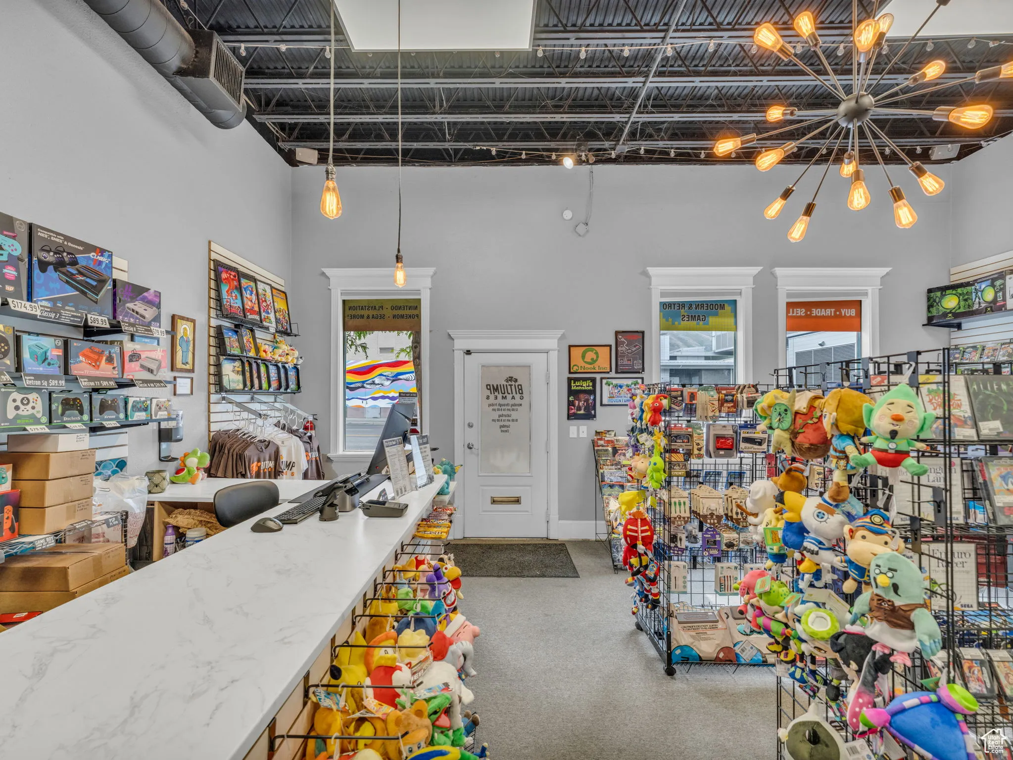 Miscellaneous room with carpet floors, a chandelier, and a high ceiling