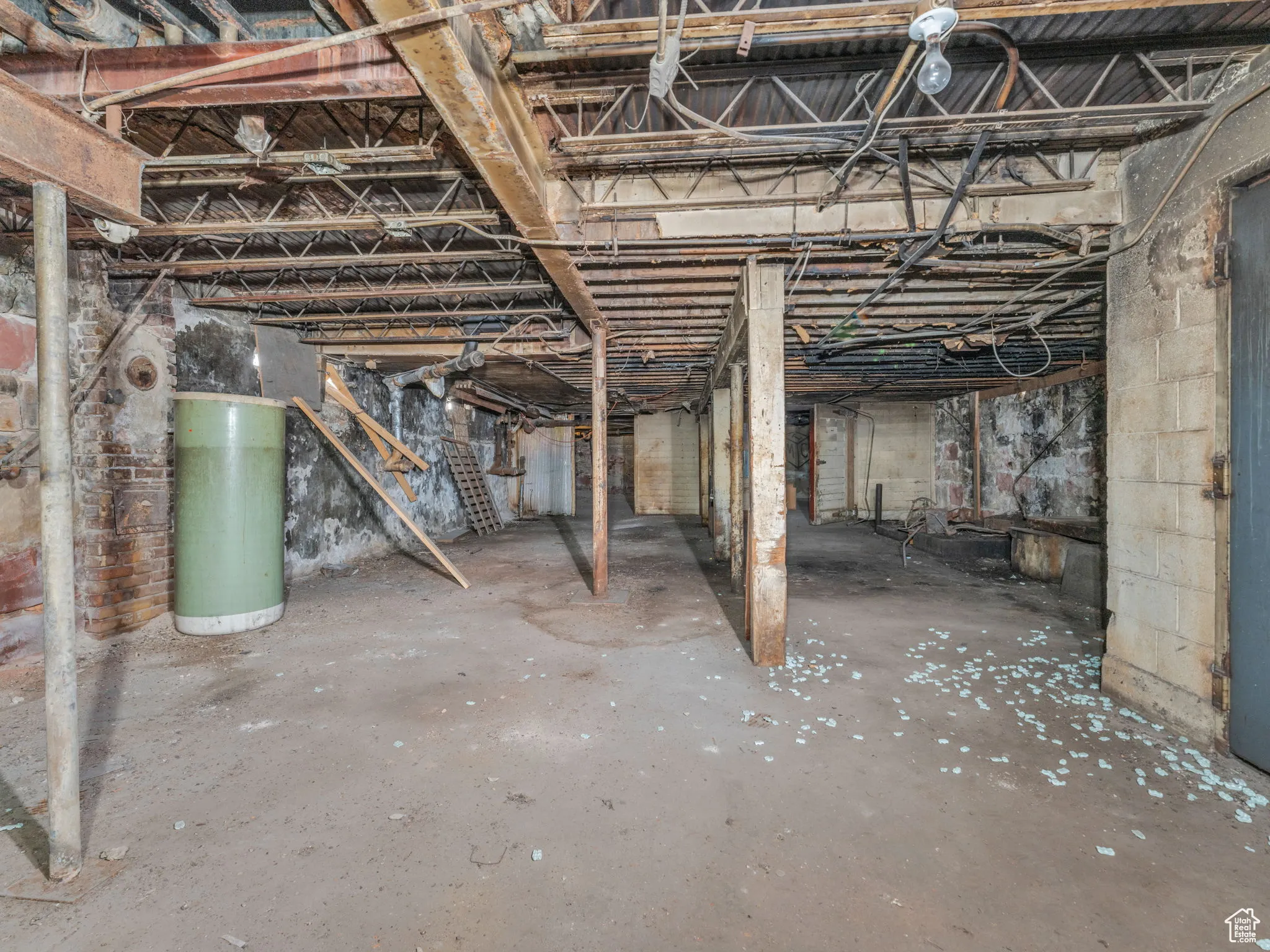 Unfinished below grade area featuring water heater