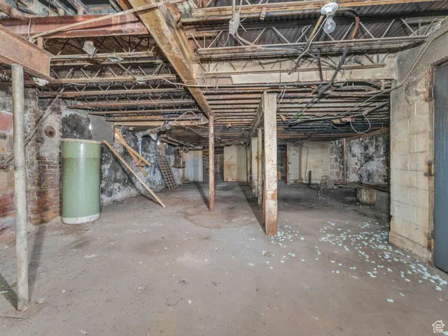 Unfinished below grade area featuring water heater