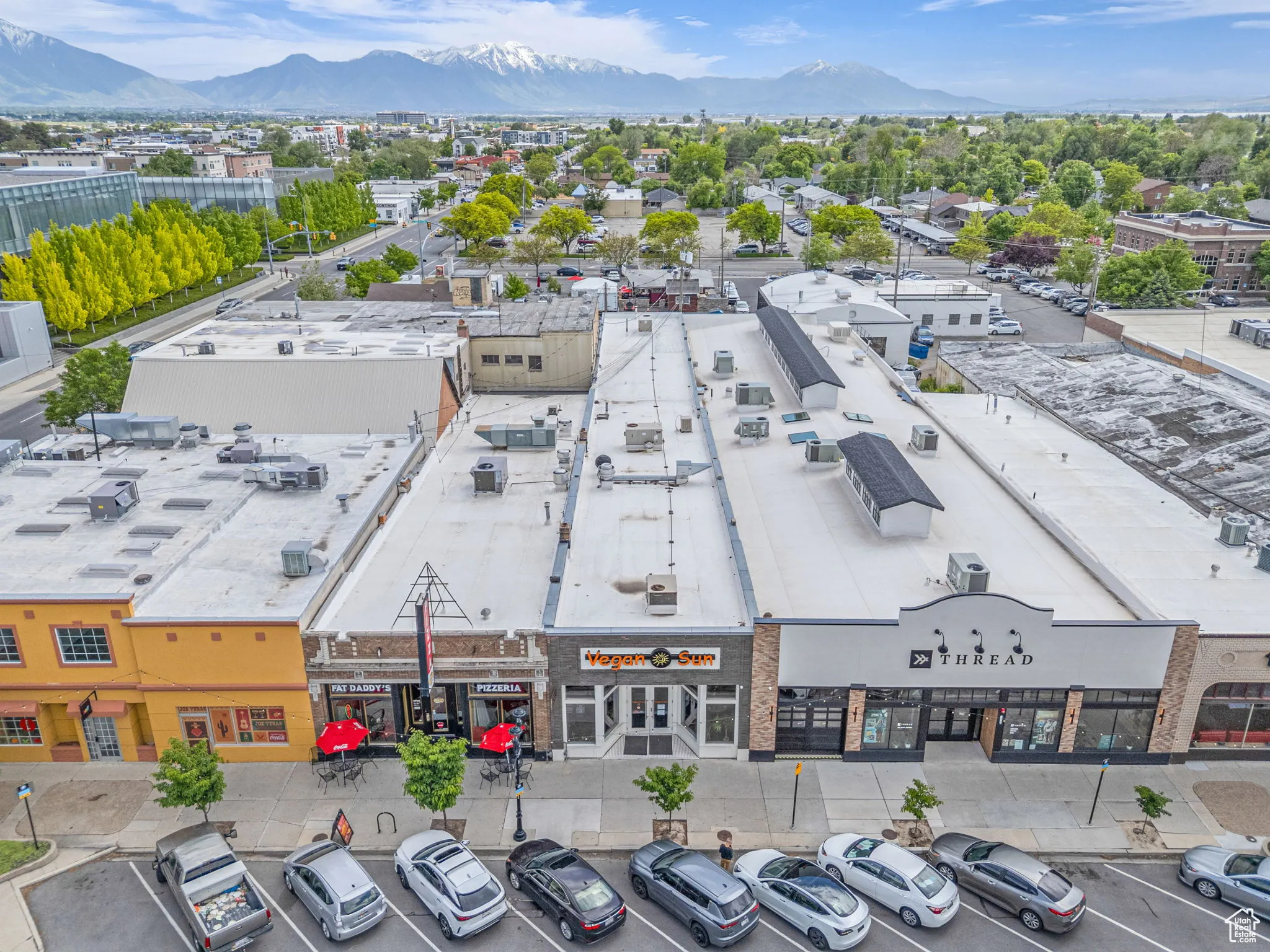 Drone / aerial view of a commercial area and mountains