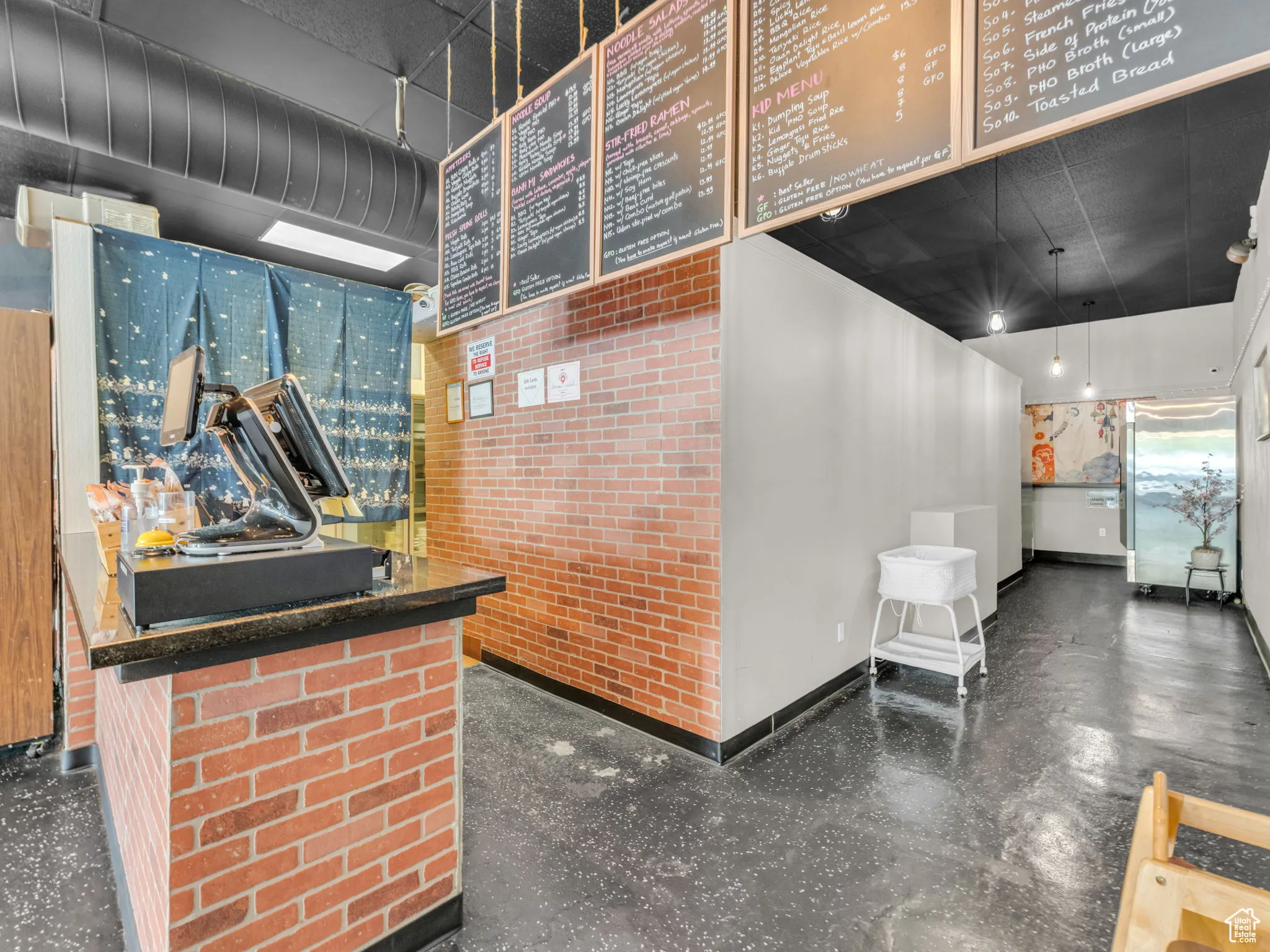 Miscellaneous room featuring baseboards and brick wall