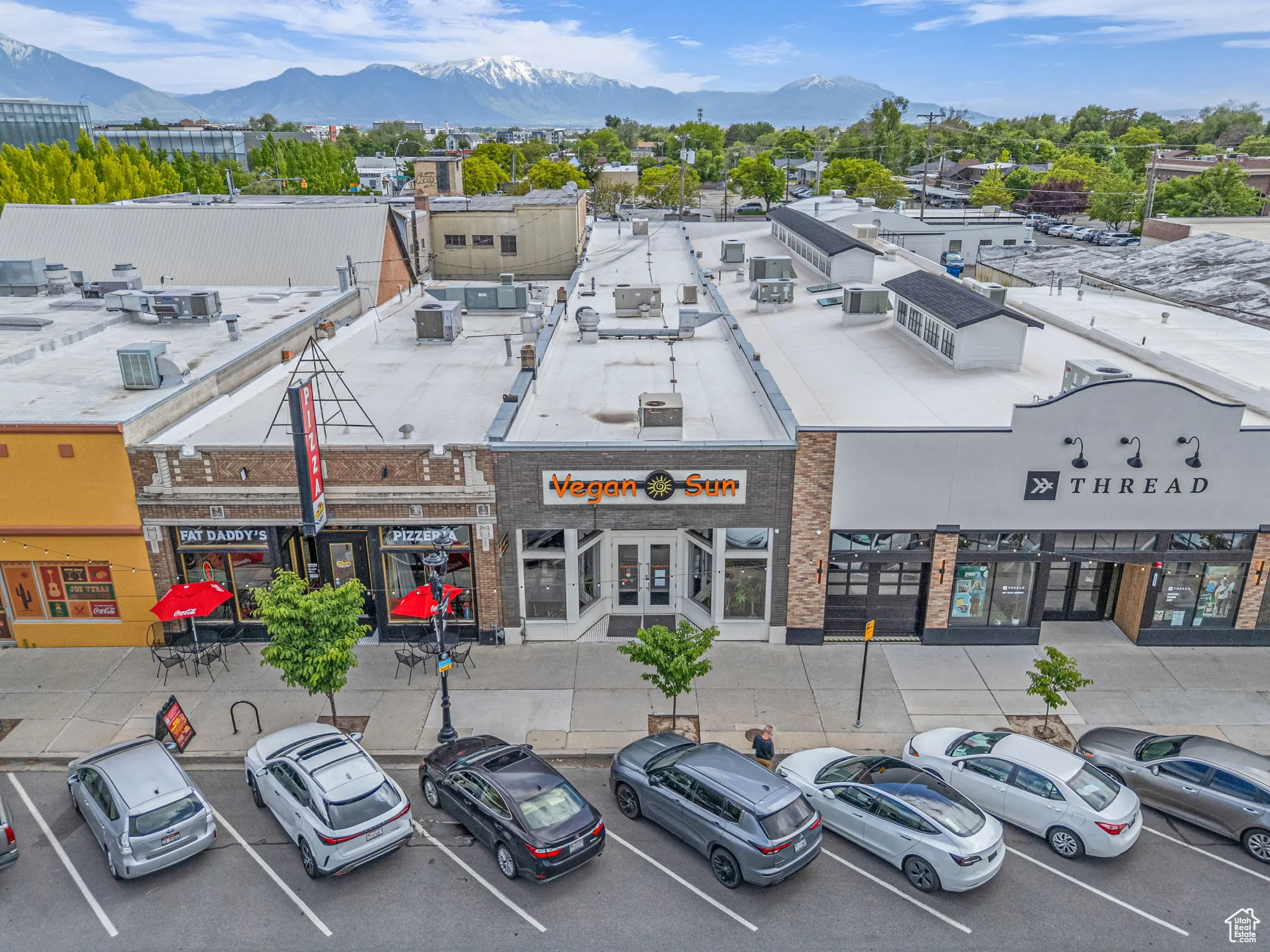 View of commercial location featuring a mountain view and uncovered parking