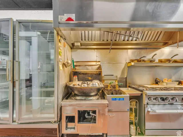 Kitchen featuring stainless steel range with gas stovetop and wood finished floors