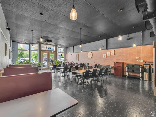 Dining space with finished concrete floors and brick wall