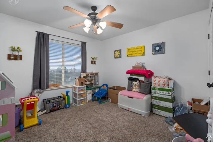 Rec room with carpet flooring and a ceiling fan