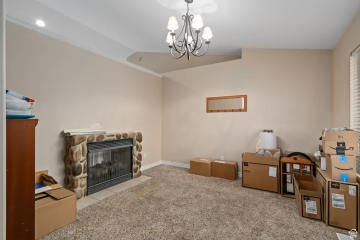 Living area featuring carpet flooring, a chandelier, a fireplace, recessed lighting, and crown molding
