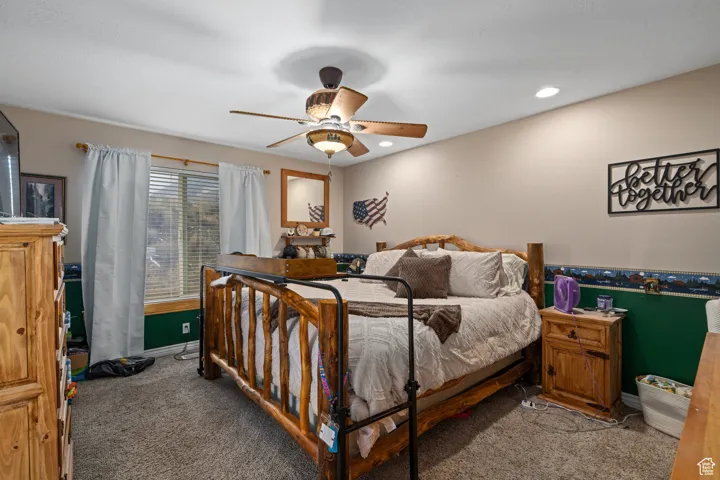 Carpeted bedroom with baseboards, recessed lighting, and a ceiling fan