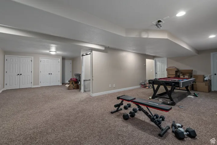 Game room with baseboards and carpet